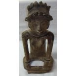 Unusual South American pottery figure of a seated woman wearing headdress (38cm high)
