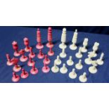 Early 20th C red stained and white carved ivory chess set (maximum height 7.