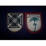 German WWII Afrika Corp cloth badge and another Swastika set with iron cross cloth badge (2)