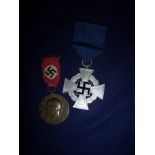 Two German WWII type medals including HItler medal with embroidered Swastika ribbon and another (2)