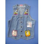 Denim waist coat with a selection of Elvis Presley patches and two Elvis Presley stamps