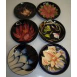 Six Moorcroft dishes of various designs (diameter 12cm) including trial pieces and seconds