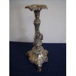 Elaborate silver plated candlestick on three raised supports with embossed detail (42cm high)