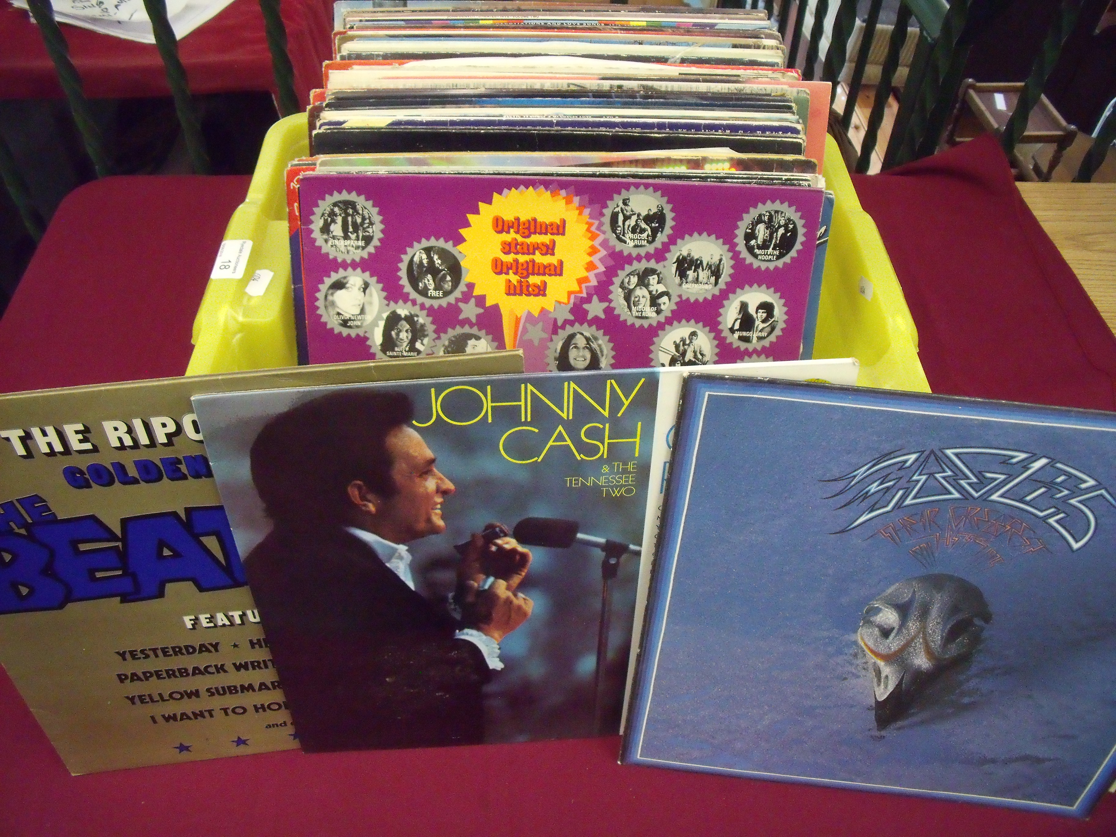 A box containing a large collection of LP records including 'Johnny Cash', 'Rod Stewart', 'Eagles',