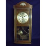 Early 20th C oak cased steel faced wall clock enclosed by bevel edged multi-sectional glazed door