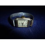 9ct gold cased rectangular faced Avia ladies wrist watch with plated bracelet strap
