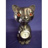 Unusual carved wood figure cat with glass inset eyes and inset steel faced Newport wind up clock