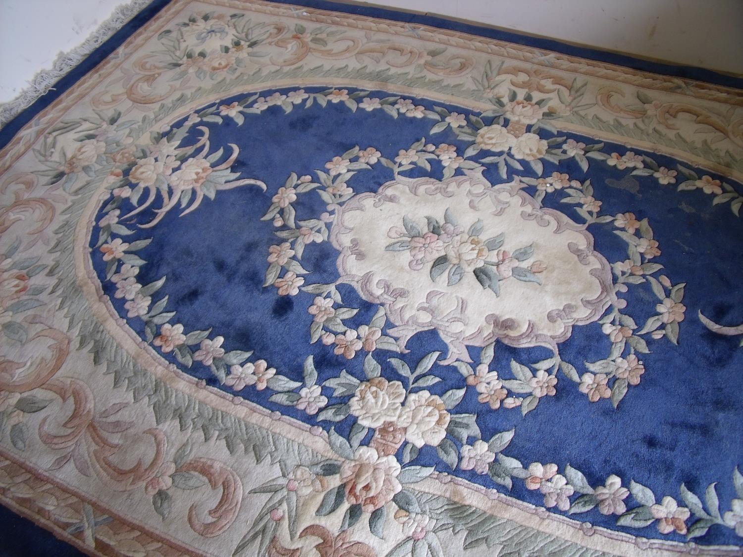 Large blue & beige ground Chinese woollen rug with central floral panel (185cm x 205cm)