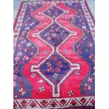 Red & blue ground Persian pattern woollen rug (159cm x 230cm)