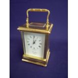 Large brass cased carriage clock enclosed by five bevel edged glass panels, the white dial marked St