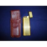 Cartier of Paris Swiss made gold plated pocket lighter with ribbed detail, the base stamped 23540G