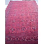 Red ground Persian style rug, with central triple square repeating pattern (204cm x 310cm)