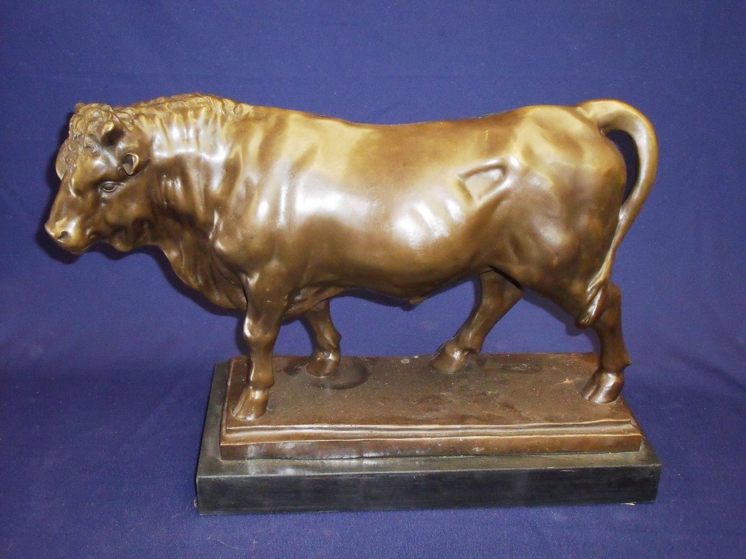 Large bronze figure of a bull on rectangular marble base (48cm x 19cm x 34cm)