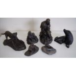 Six carved coal and other bronzed effect figures of dogs, lovers, seals etc