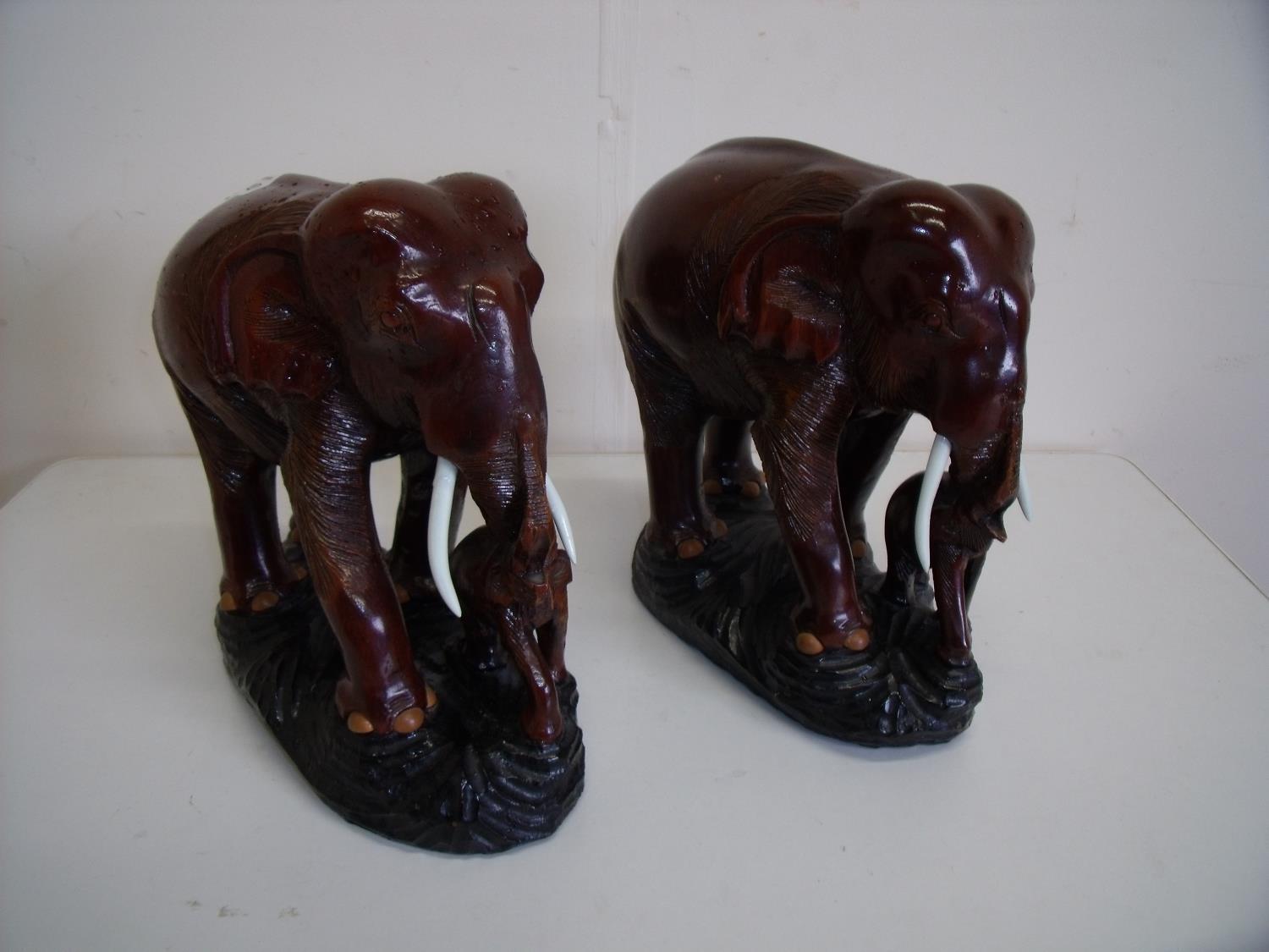 Pair of carved hardwood figures of elephants with calf (25cm high)