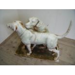 Unusual and large extremely heavy cast metal garden statutory figures of two working dogs, one