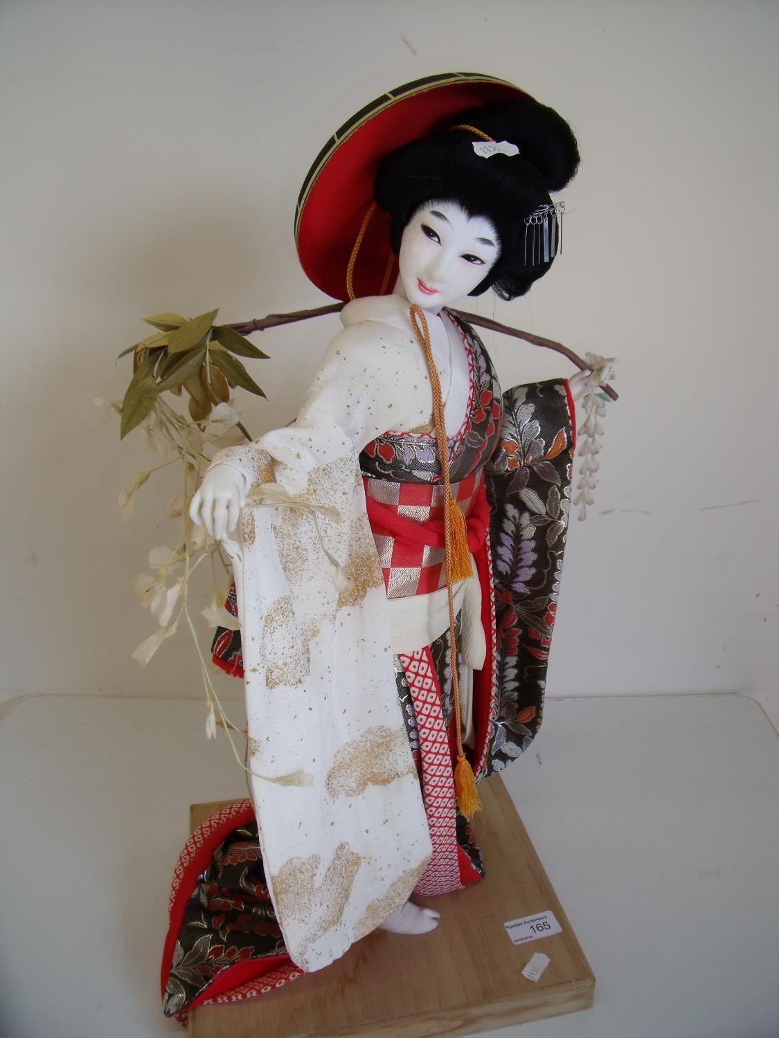 Figure of a Geisha girl in wooden plinth (62cm high)