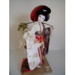 Figure of a Geisha girl in wooden plinth (62cm high)