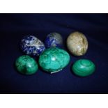 Group of six carved stone eggs including malachite, lapis etc. of various sizes ranging approx. 4.