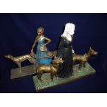 Two similar mid 20th C French plaster figures depicting lady with dogs on rectangular bases, one