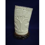 Early 20th C carved ivory figure depicting wildlife, on carved wood stand (overall height 26cm)