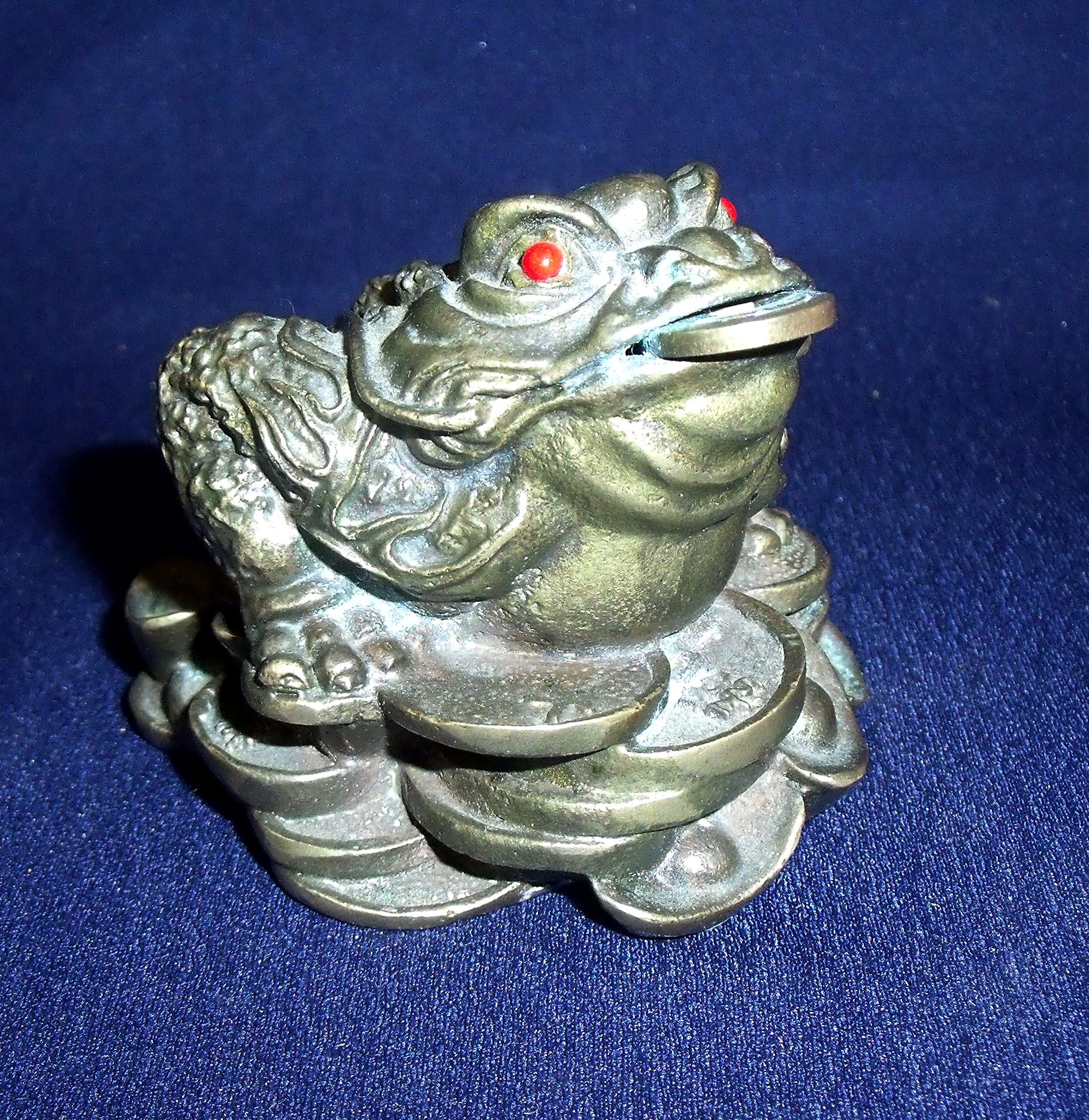 Small early to mid 20th C Chinese bronze figure of a toad with coin in its mouth seated upon a