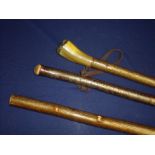 Group of three shepherds style walking sticks with plain handles, one set with horn grip and Game