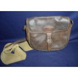 Vintage brown leather cartridge bag with canvas lining and shoulder strap