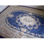 Large blue & beige ground Chinese woollen rug with central floral panel (185cm x 300cm)