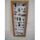 Glazed framed and mounted display of various metal detector and archaeological finds including