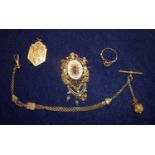 An elaborate and ornate Victorian gilt metal brooch set with central stone and mounted with