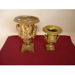 Pair of plasterwork gilt painted urns of classical design (34cm & 24cm high)