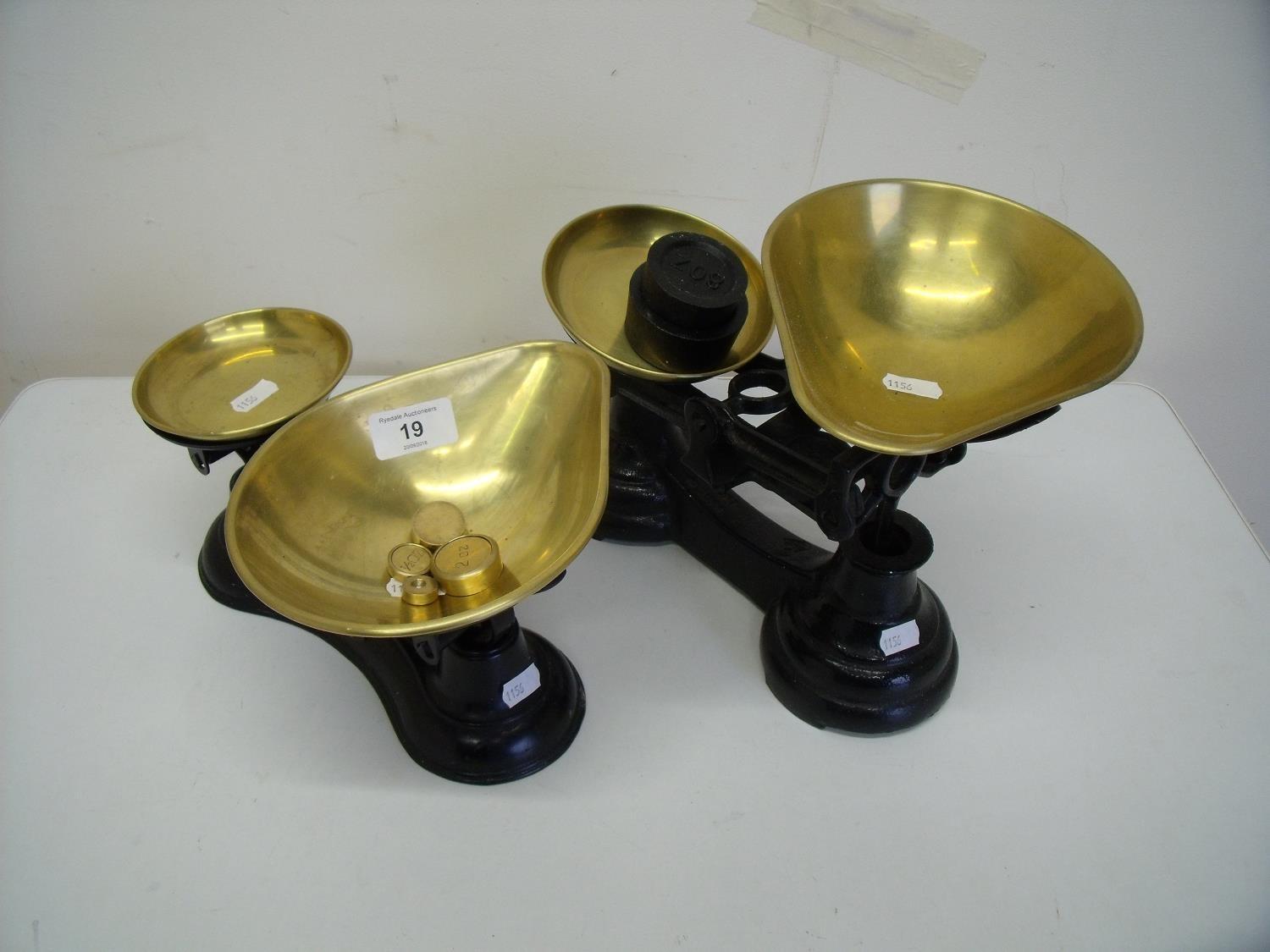 Two sets of brass and cast metal kitchen scales with associated weights