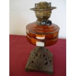 19th/20th C oil lamp with amber glass reservoir and cast metal base