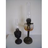 Late Victorian oil lamp with clear glass reservoir and another with embossed spelter type body (2)