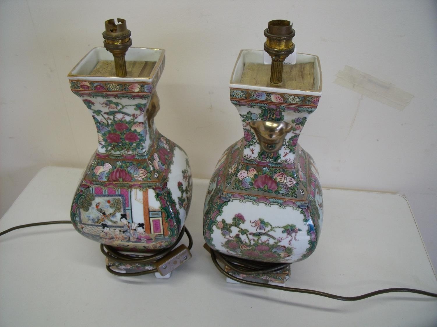 Pair of oriental ceramic table lamps of square bulbous form on raised bases (height 40cm)