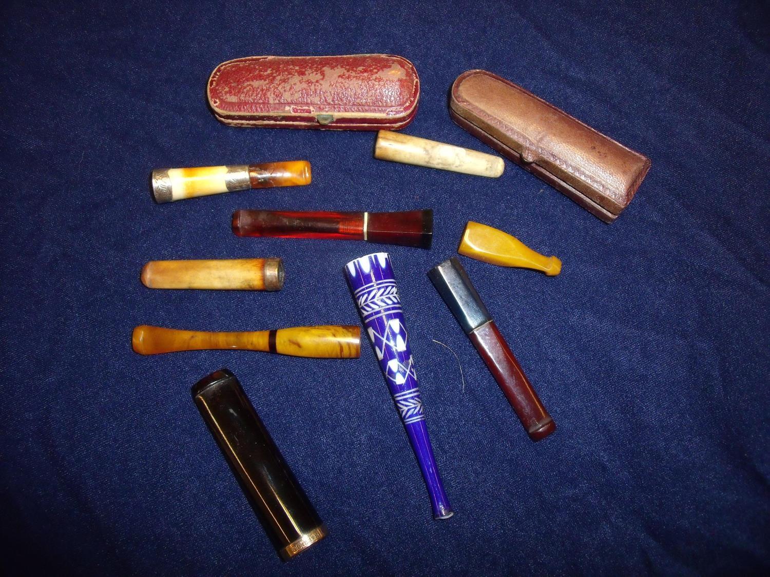 Selection of various cheroot holders in one box including blue overlaid glass, amber, bone etc