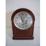 Edwardian mahogany inlaid arch top steel faced chiming mantle clock on raised bun feet, the movement