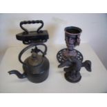 Cast metal tea pot, cast metal door stop in the form of a French eagle, urn, flat iron and trivet