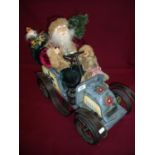 Large model of Santa Claus in a decorative model vehicle