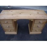 Waxed pine twin pedestal kneehole dressing chest with three drawers to each pedestal, with raised