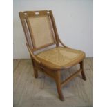 Early 20th C bedroom chair with Bergere seat and back, with storage drawer underneath