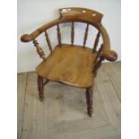 Elm smokers bow type chair on turned supports and H shaped under stretcher