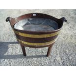 Early 19th C oval mahogany and brass bound wine cooler with led liner on four raised supports and