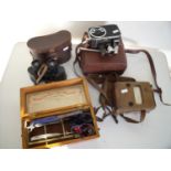 Cased binoculars, vintage cine camera, amp meter and an electric shock type machine