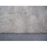 Extremely large beige woollen style shaggy rug