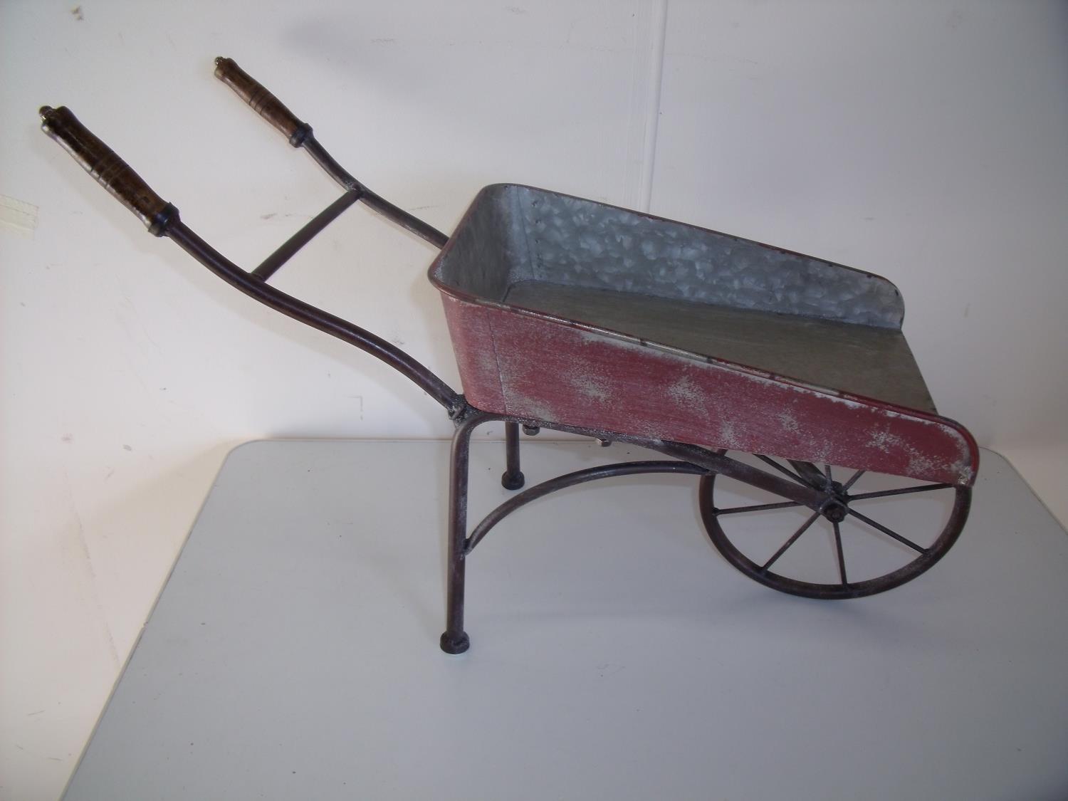 Metal constructed model of a vintage wheelbarrow (overall length 65cm)