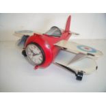 Modern painted tin plate clock in the form of a bi-plane
