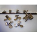 Selection of cow type bells on leather strap, brass and silver plated propeller blades and a brass