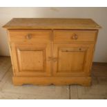 Waxed pine side cabinet with two drawers above two panelled cupboard doors (106cm x 42cm x 84cm)